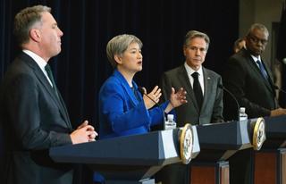 Penny Wong and other ministers speaking at podiums